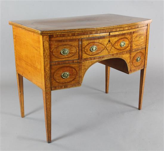 A George III rosewood banded satinwood bowfront dressing table, W.3ft 6in. D.2ft 2in. H.2ft 10in.